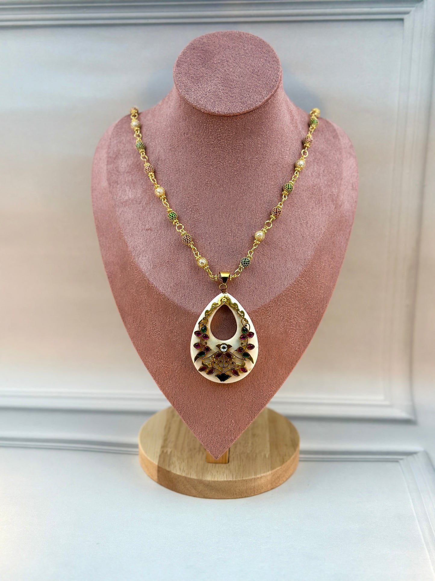 Big White Oval Shaped Pendant With Gold Work